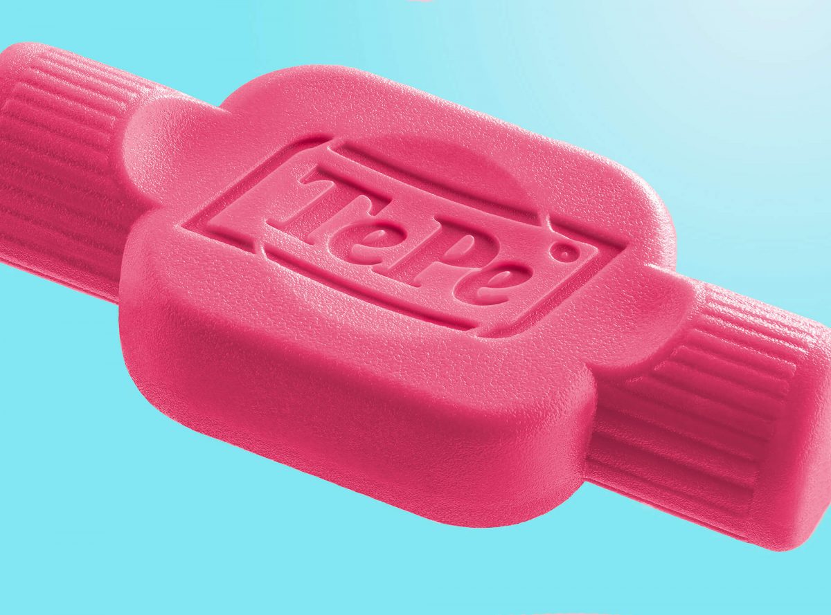 TePe close-up tooth brush. Pink product and colorful background. 